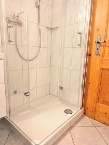 a shower with a glass door in a bathroom at Ferienwohnung Soiernblick Krün Bärnbichl in Krün +25 photos