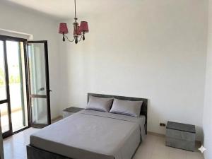 a bedroom with a bed and a chandelier at Villa Vit The Adriatic Experience in Vasto +7 photos