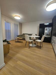 a living room with a table and chairs and a couch at 365 apartmány AUPARK in Piešťany