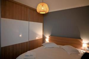 a bedroom with a large white bed and a lamp at Thea Hill in Kritharia +12 photos