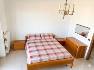 a bedroom with a bed and a mirror and a chandelier at Villa Vit The Adriatic Experience in Vasto