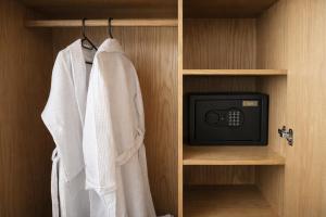 a small tv in a closet with a towel at Garden Atelier - Private Cenote & Steps from the Beach in Tulum