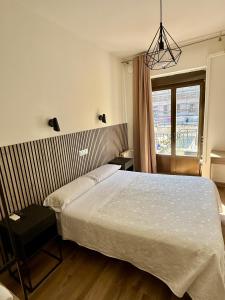 a bedroom with a large bed and a window at Hostal Fernández Atocha in Madrid