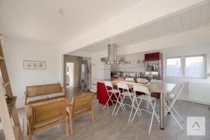 a kitchen and dining room with a table and chairs at La Cabane à Hirel in Hirel