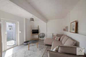 a living room with a couch and a tv at La Cabane à Hirel in Hirel
