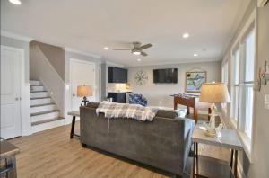a living room with a couch and a table at 5 BR Poolside Paradise Just Steps from the Beach in Ocean Isle Beach
