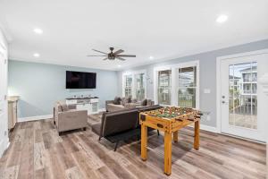 a living room with a couch and a table at East End Views in Ocean Isle Beach