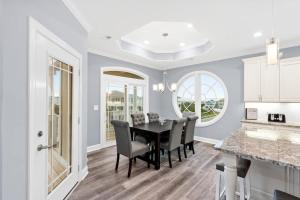 a dining room with a black table and chairs at East End Views in Ocean Isle Beach +28 photos