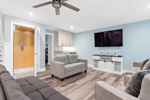 a living room with a couch and a tv at East End Views in Ocean Isle Beach