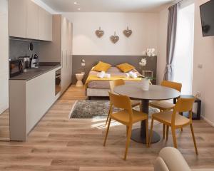 a bedroom with a bed and a table and chairs at Da Franca in Riva del Garda +23 photos
