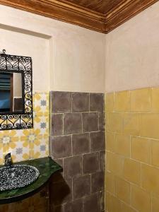 a bathroom with a sink and a mirror at auberge atlas tamatertt in Imlil