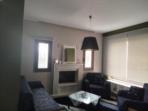 a living room with a couch and a fireplace at Grace, fifteen minutes drive away from the beach in Kolymvari