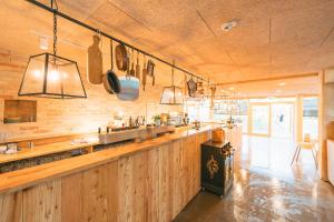 a kitchen with a long counter and a bar at Budgetzimmer Erlebnishof Gut Hügle in Ravensburg