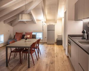 a kitchen and dining room with a table and chairs at Da Franca in Riva del Garda