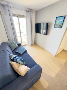 a blue couch with pillows in a living room at NextGen Casa Pepa I Terrace & Pool Fuerteventura in Costa de Antigua