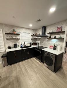 a kitchen with a sink and a dishwasher at Uptown Modern Escape 4bd 2ba in Memphis