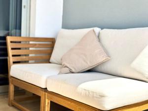 a white couch with two pillows on top of it at NextGen Casa Pepa I Terrace & Pool Fuerteventura in Costa de Antigua +42 photos