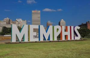 a large sign with a city in the background at Uptown Modern Escape 4bd 2ba in Memphis