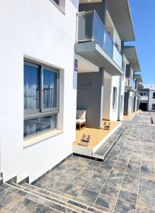 a building with a balcony on the side of it at NextGen Casa Pepa I Terrace & Pool Fuerteventura in Costa de Antigua