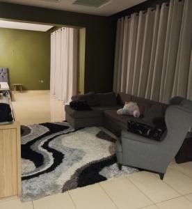 a living room with a couch and a rug at Grace, fifteen minutes drive away from the beach in Kolymvari