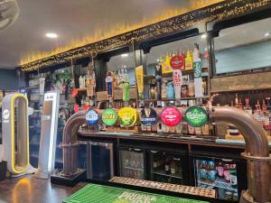 a bar with a lot of bottles of alcohol at Harbour Moon Inn in Looe