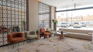 a lobby with chairs and a waiting room at Rosa Grand Hotel Granada in Riyadh