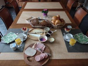 a table with breakfast foods and drinks on it at Dielpenhof in Zedelgem +16 photos