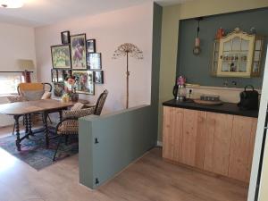 a kitchen with a table and a dining room at Kade10Buren in Buren +18 photos