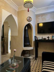 a living room with a fireplace and a tv at Kasba blanca in Tangier