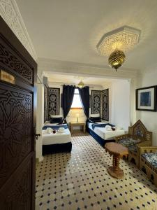 a bedroom with two beds and a table in it at Kasba blanca in Tangier +117 photos