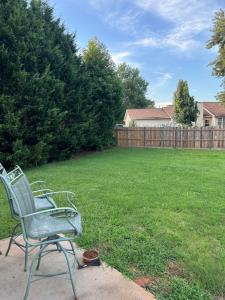 a green chair sitting in a yard next to a lawn at Country house in Covington