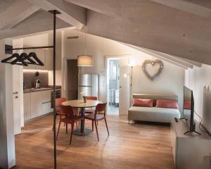 a kitchen and living room with a table and chairs at Da Franca in Riva del Garda