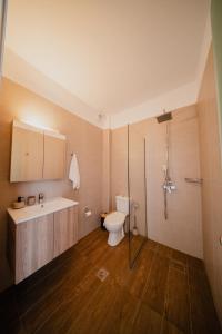 a bathroom with a toilet and a sink at Indigo Seaside Experience in Adelianos Kampos +71 photos