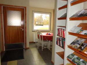 a room with a table and a window and a door at Målerås B&B Guesthouse in Målerås
