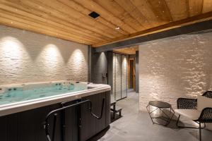 a bathroom with a jacuzzi tub at Appartement Gondola & Spa - MultiPass in Les Gets +32 photos