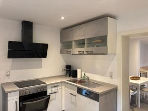 a kitchen with a sink and a stove top oven at Salinenappartement in Bad Kreuznach