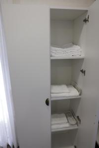 a closet with white shelves and folded towels at Armenian Corner Hotel in Pʼarakʼar +33 photos
