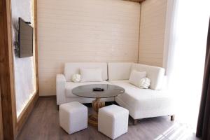 a living room with a white couch and a table at Armenian Corner Hotel in Pʼarakʼar