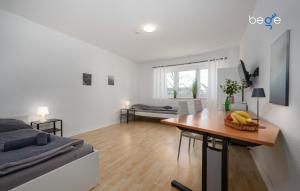 a living room with a bed and a table with a bowl of fruit at BEGE APARTMENTS ProStay in Lüdenscheid