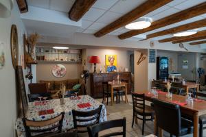 a dining room with tables and chairs in a restaurant at Auberge du Cezallier in Montgreleix