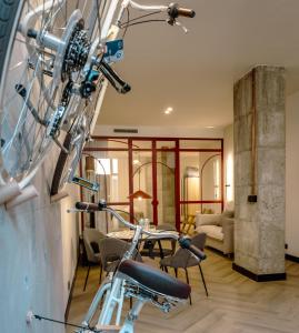 a living room with a bike in the foreground at Castelar Urban Suites in Badajoz