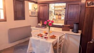 a kitchen with a table with a vase of flowers at Le Puits Enchanté in Espalion