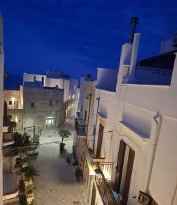 an alley with white buildings at night at Brezza Marina in Polignano a Mare