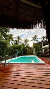 a swimming pool on top of a wooden deck at Pousada Nascer do Sol in Marau