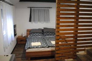 a bedroom with a bed with black and white pillows at DIÓ Vendégház in Balatonfenyves