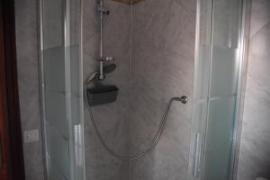 a shower with a hose in a bathroom at Casa Luisa in Sarroch