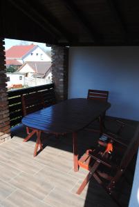 a black table with two chairs on a patio at DIÓ Vendégház in Balatonfenyves