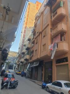 a street with cars parked next to a building at Apartment Alexandria City Center in Alexandria