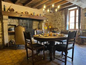 a dining room with a wooden table and chairs at Charming BB Room in Historic Saint-Martial-le-Mont, Creuse in Saint-Martial-le-Mont +13 photos