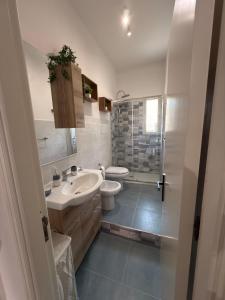 a bathroom with a sink and a toilet at La Mya Aurora in Finale +21 photos